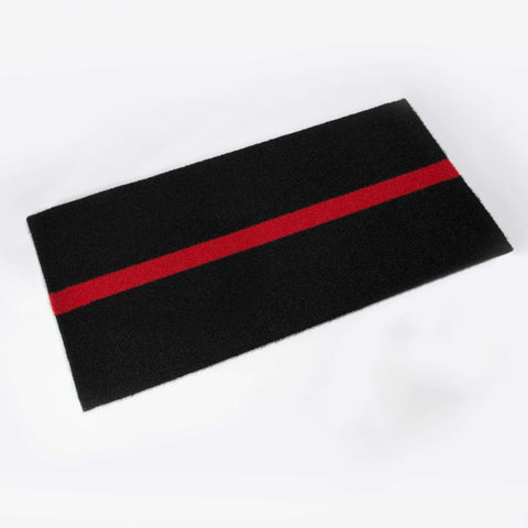 Red hitting mat with chalk lines and stride marker for baseball training